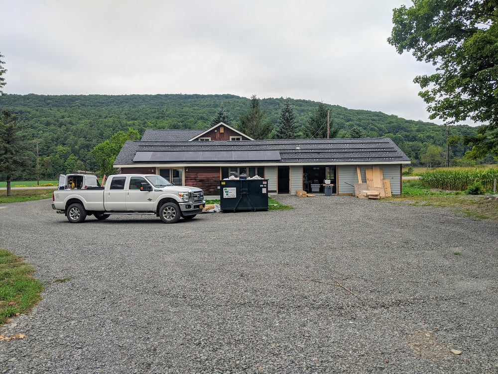 Photo of the exterior of the Newfield workshop, with mountains in the background