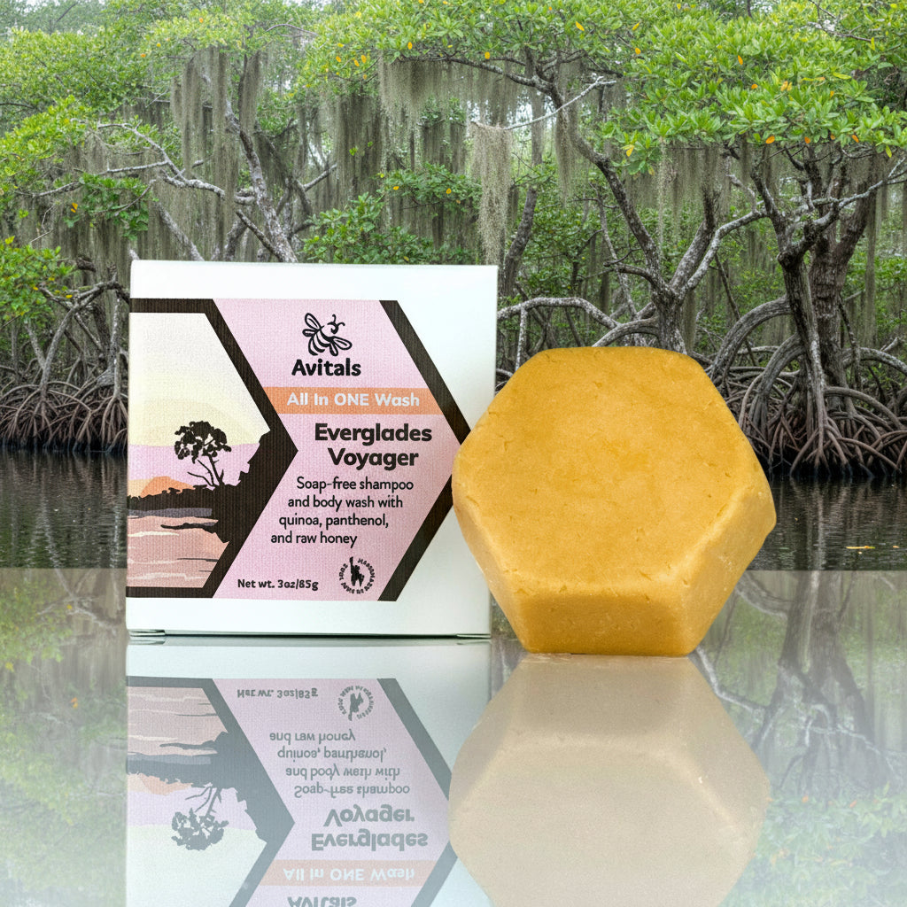 Avital's soap bar and packaging on a reflective surface with the Everglades in the background.