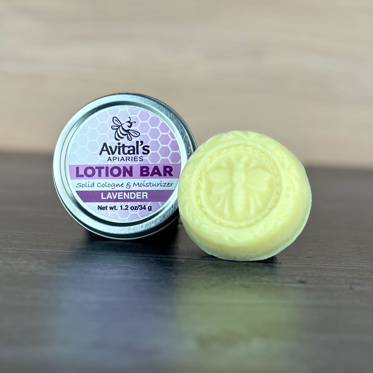 Avital's Apiaries lavender lotion bar and container on a wooden surface
