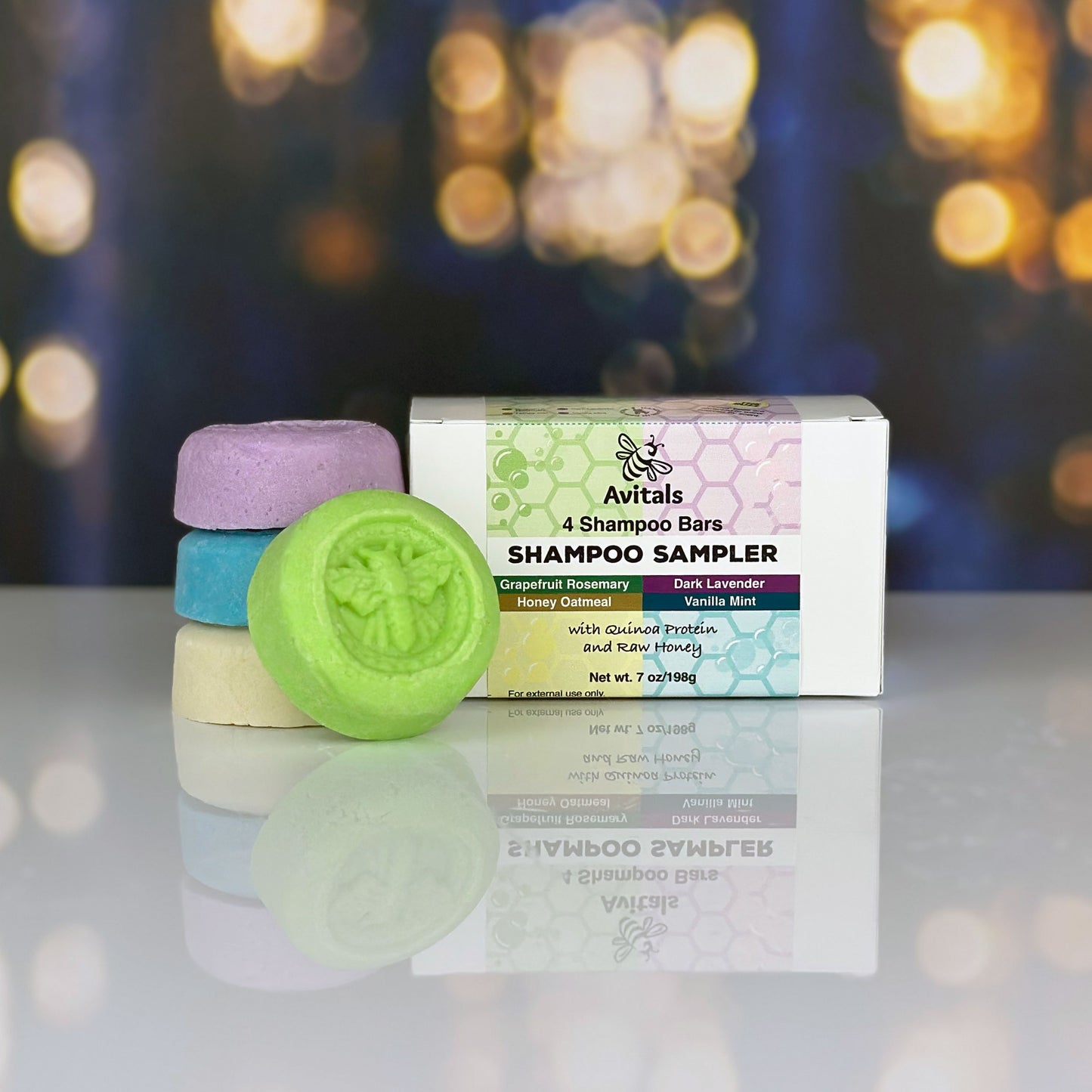 Avitals shampoo bars with a box on a reflective surface with a blurred bokeh background