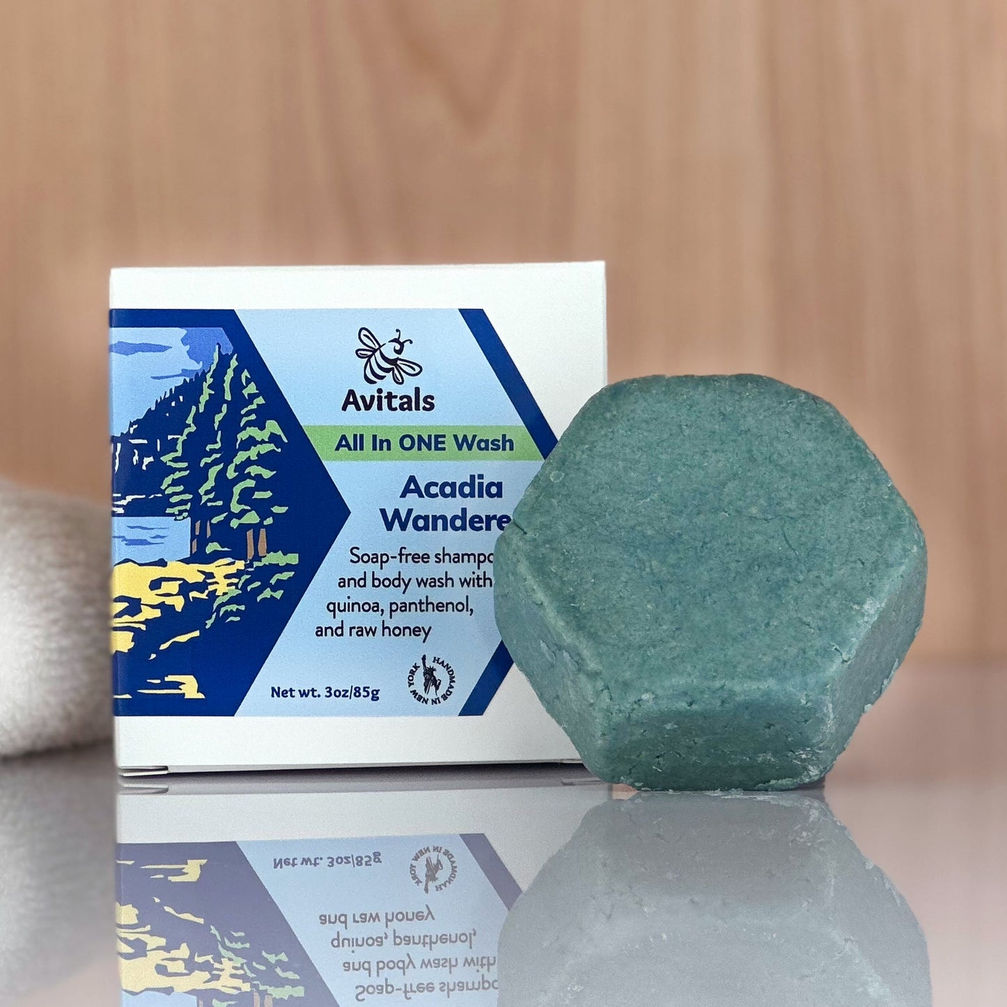 Green bar and packaging on a reflective surface with a wooden background