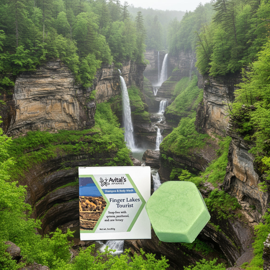 A green shampoo and body wash bar next to its packaging, which features an image of the Finger Lakes Region.