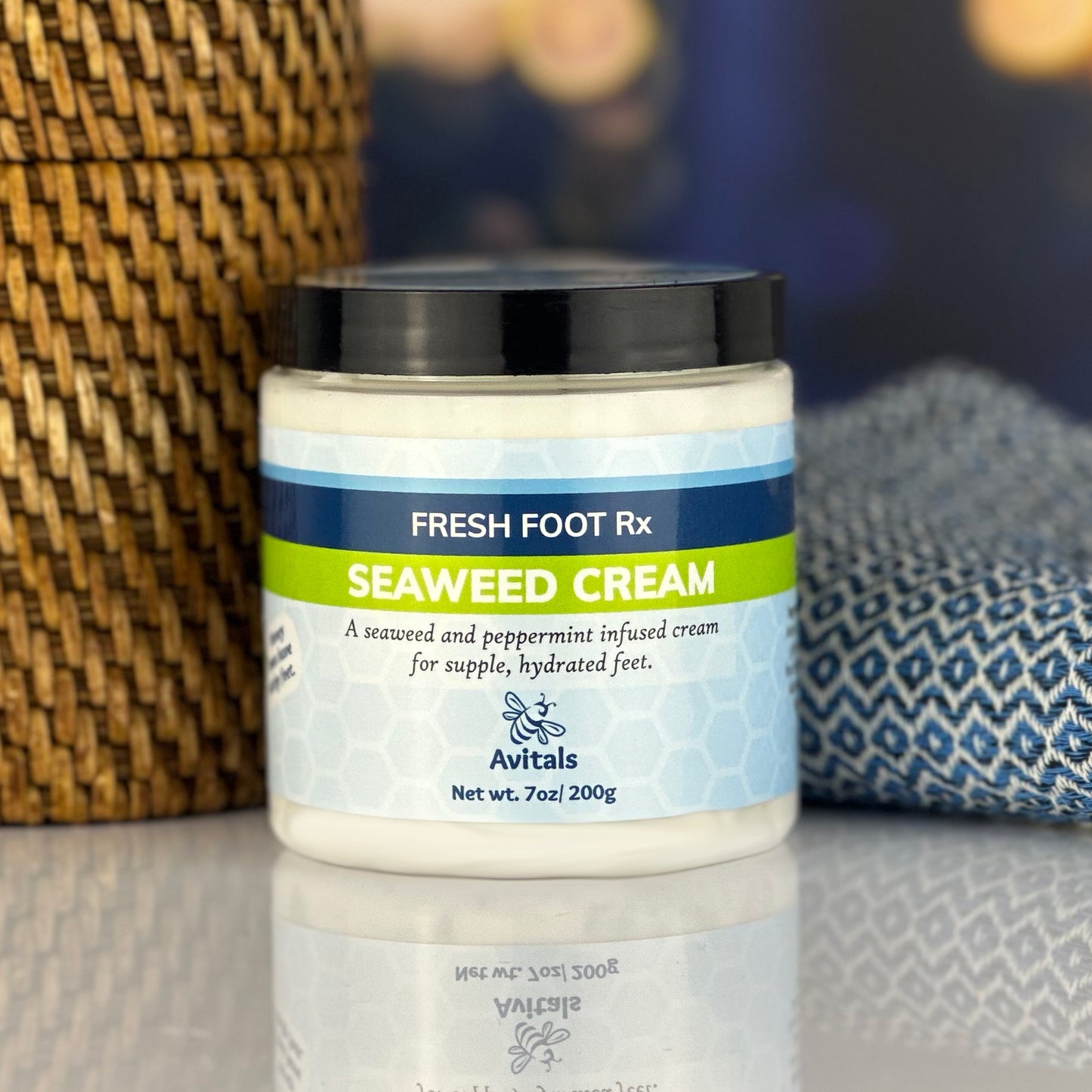 A jar of Fresh Foot Rx Seaweed Cream by Avitals, placed on a surface with a patterned fabric in the background.