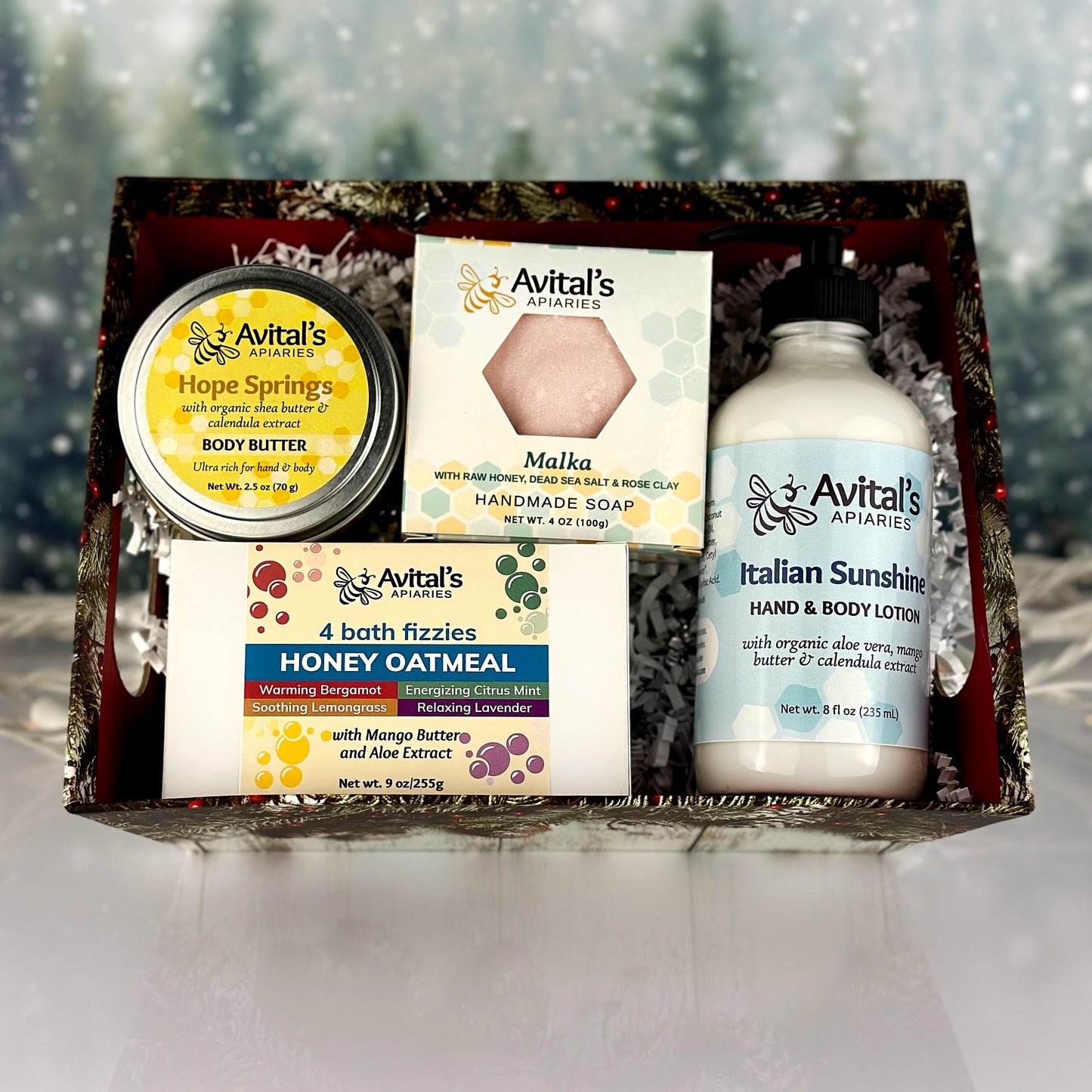 A gift set box containing various Avital's products including body butter, Dead Sea salt soap, hand and body lotion, and bath fizzy scents.