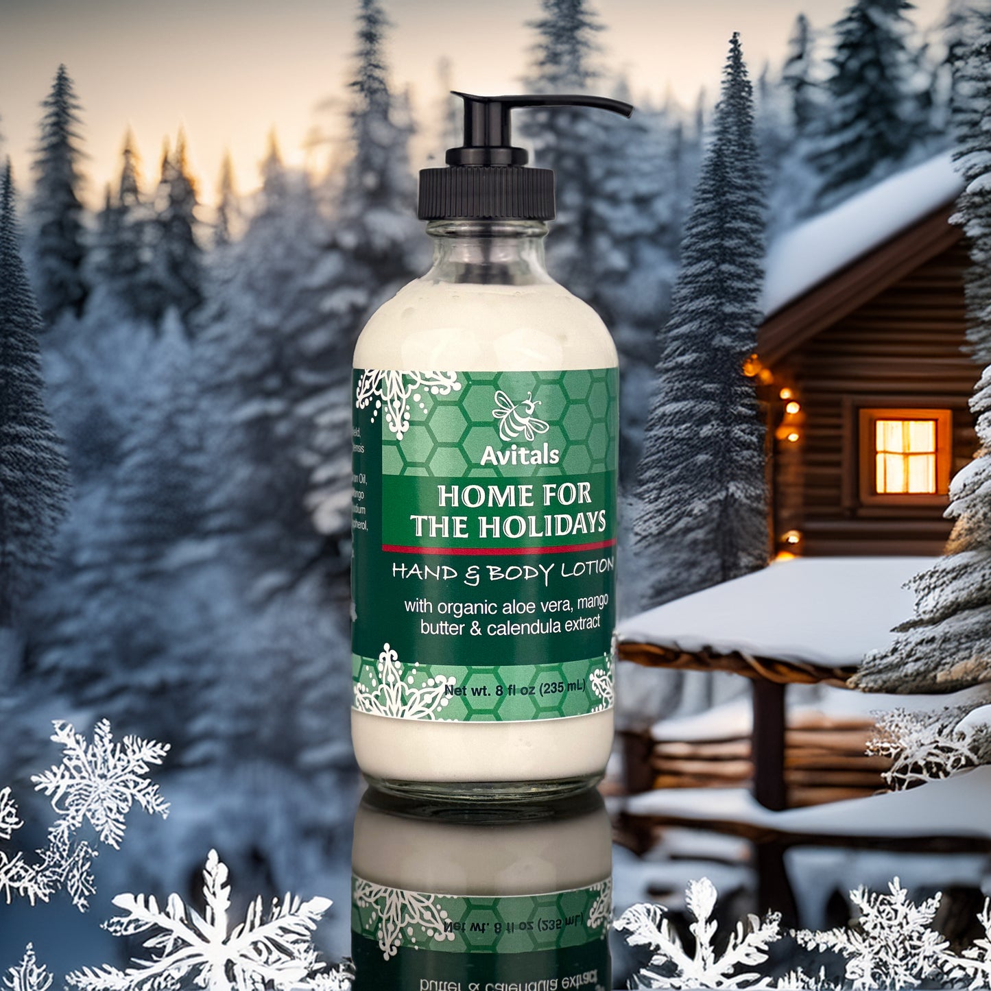 A pump bottle of Avital's Home for The Holidays Hand & Body Lotion  placed outdoors with a cabin in the background and snow on the ground.