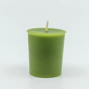A green votive candle with a center wick.