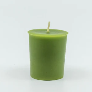 
                  
                    A green votive candle with a center wick.
                  
                