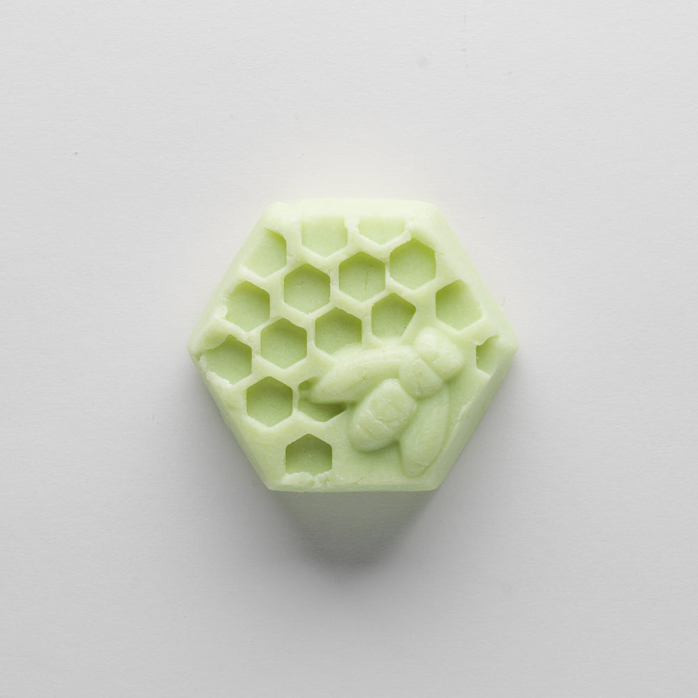 
                  
                    Green hexagonal bar with honey bee and honeycomb on the top
                  
                