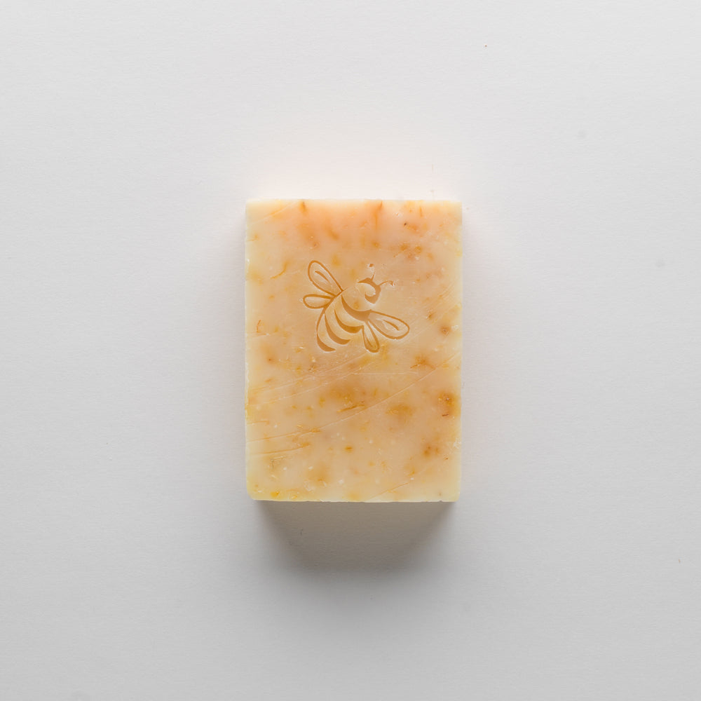 
                  
                    A yellow-orange, bee-stamped bar of Chaya's Hope on a white background.
                  
                